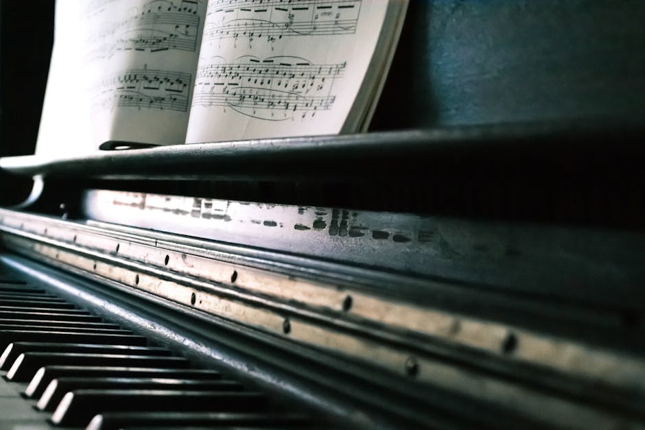 Close-up of piano keys with an open sheet music, creating a classic musical ambiance.