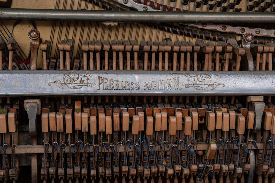 Detailed view of vintage piano strings and hammers, showcasing antique mechanics.